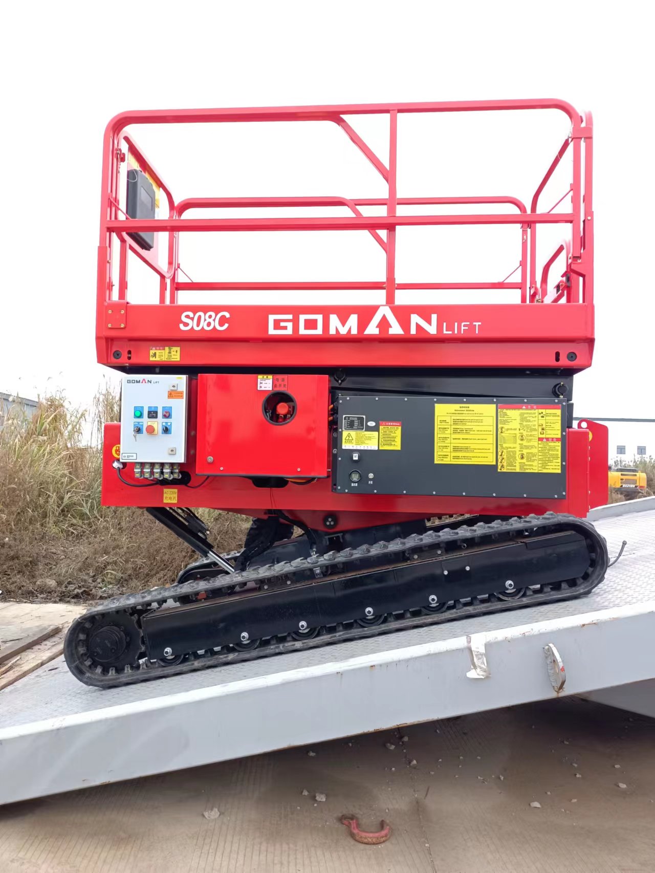 Crawler Self-Leveling Scissor Lift operating on uneven terrain